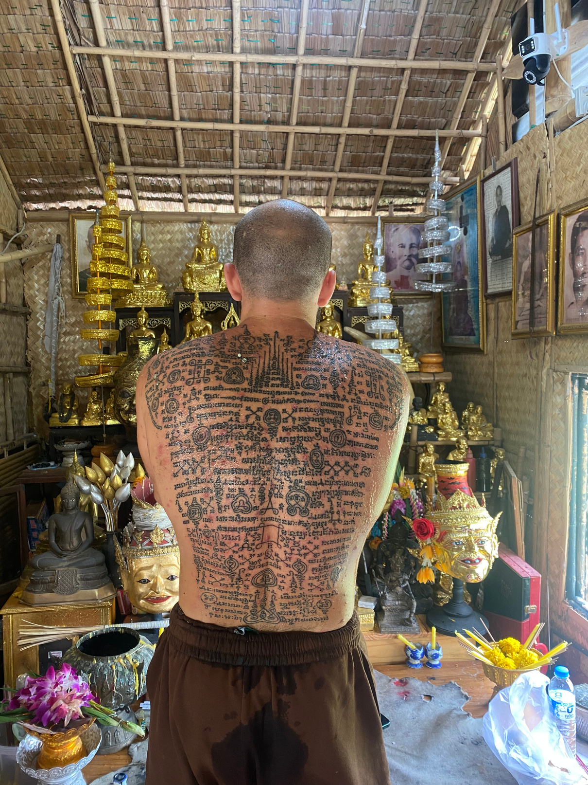 Devin Radianu with Sak Yant tattoos in a Thai temple