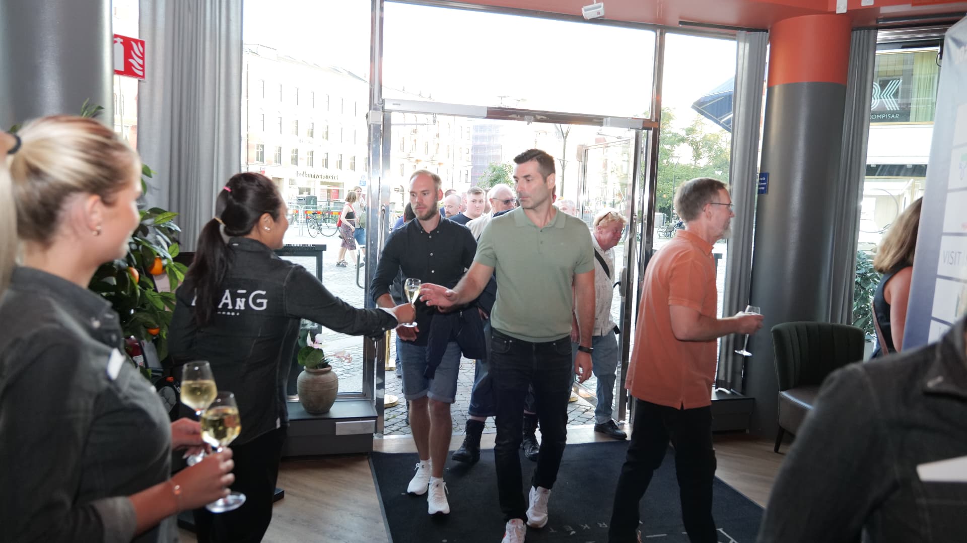 Guests arrive and are welcomed with sparkling wine by Klang Market staff