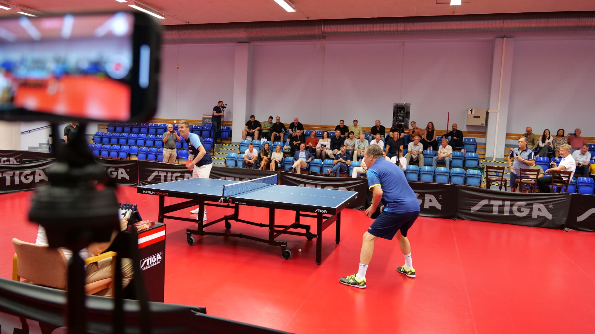 Audience watching the exhibition table tennis match during the World Champions' Dinner's day programme
