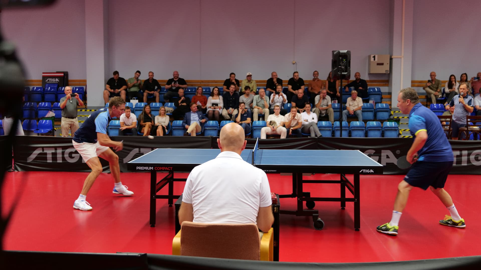 Exhibition table tennis match between Swedish legends in front of an audience at the STIGA board
